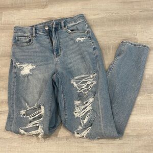 American Eagle medium wash curvy mom jeans with many rips.
